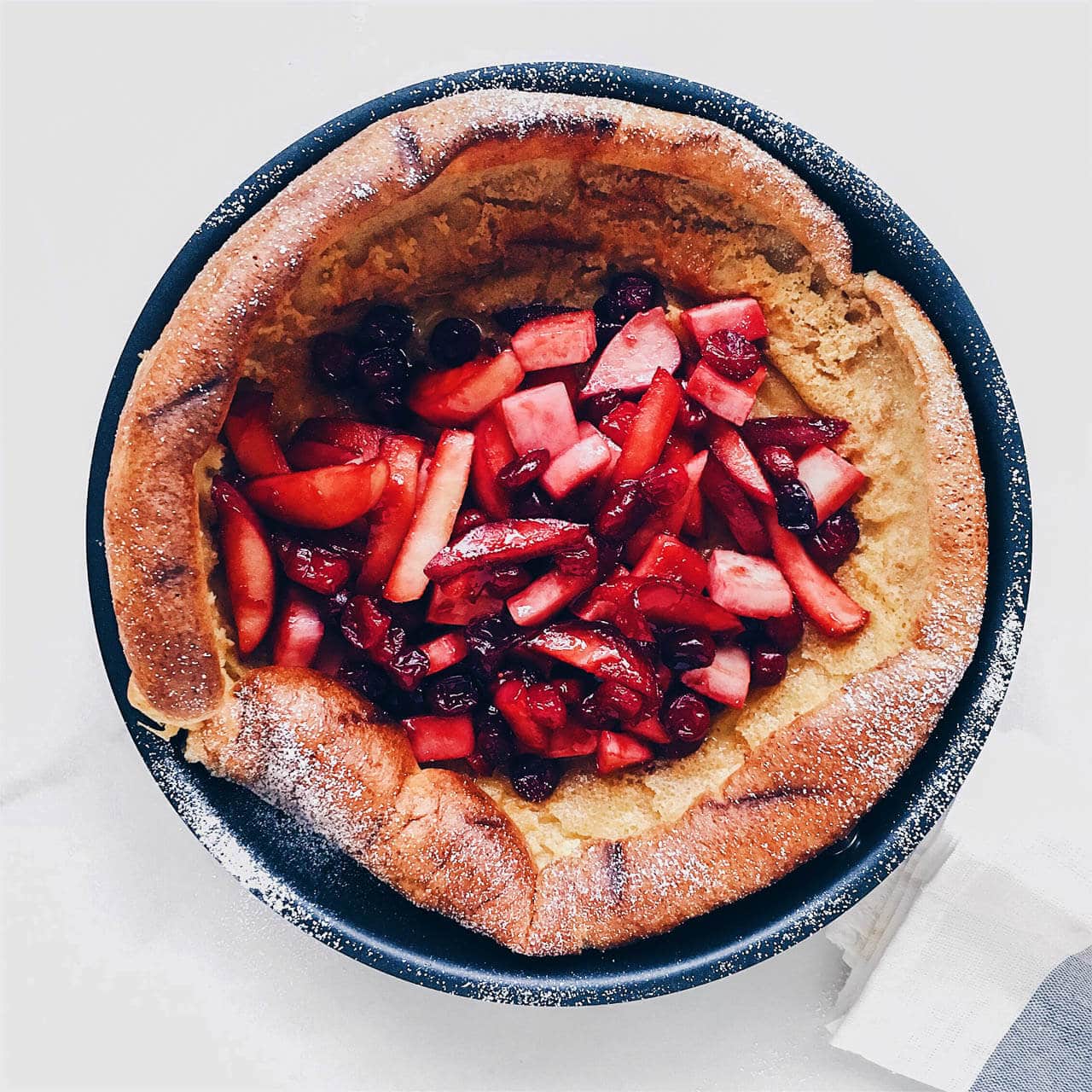 Dutch baby pancake topped with mixed fruit