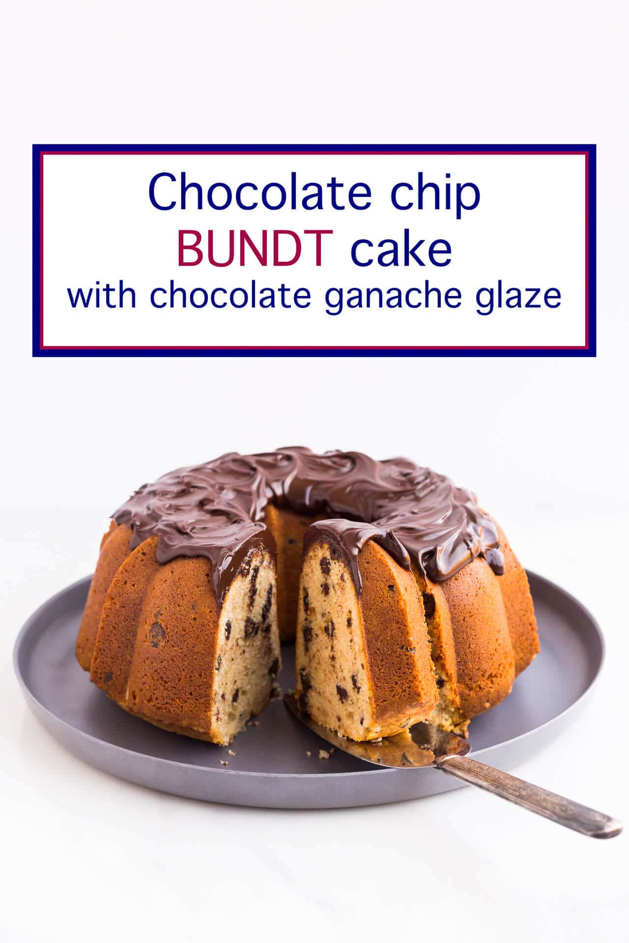 Bundt cake with chocolate chips and swirls of thick chocolate glaze being sliced and served from a grey serving platter