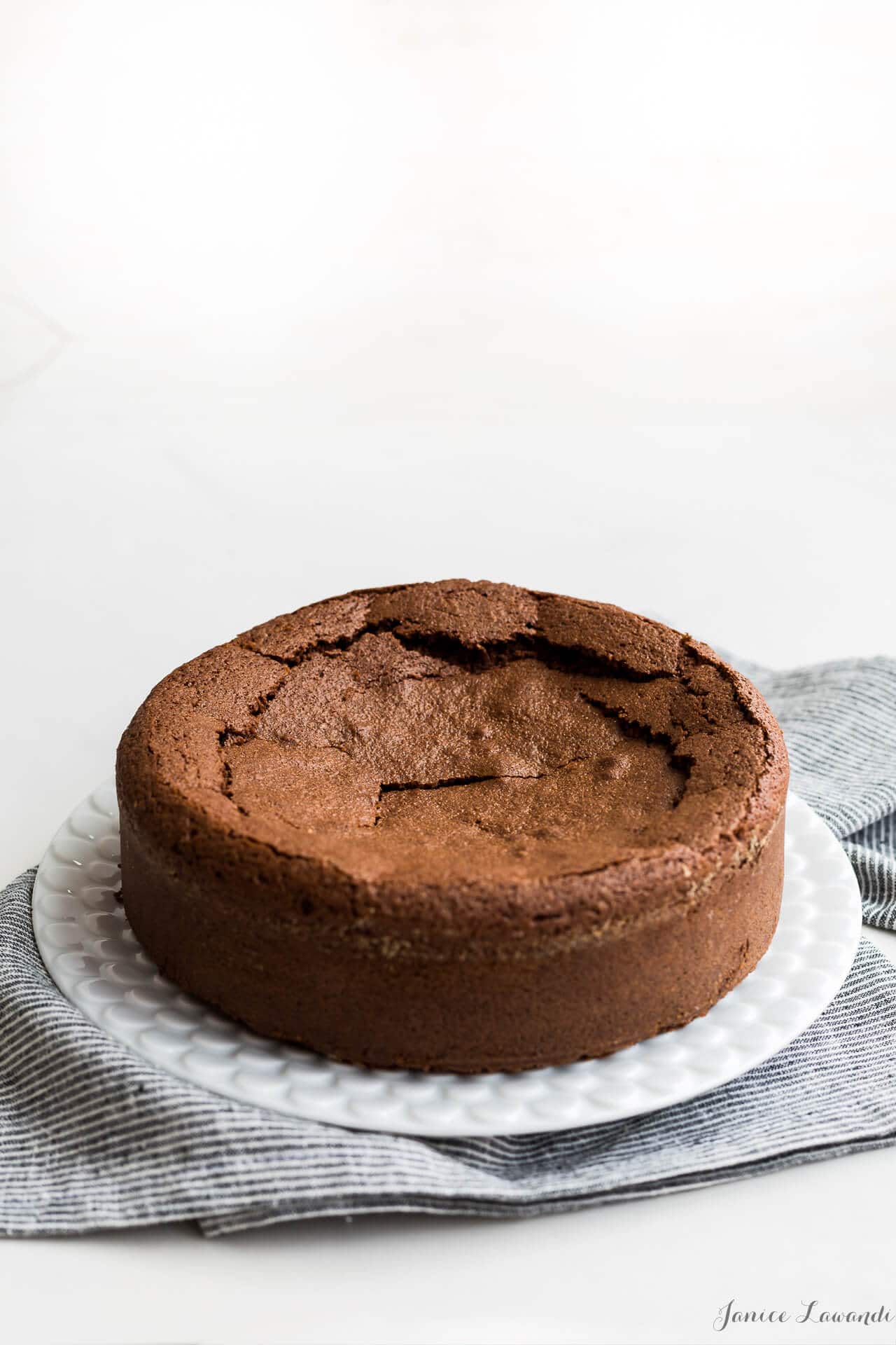 Single layer chocolate cake with a cracked sunken surface 