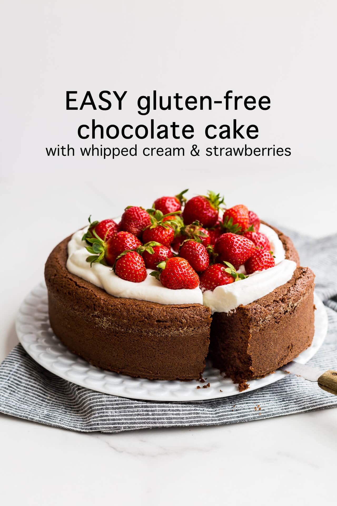 Easy gluten-free chocolate cake with whipped cream and strawberries