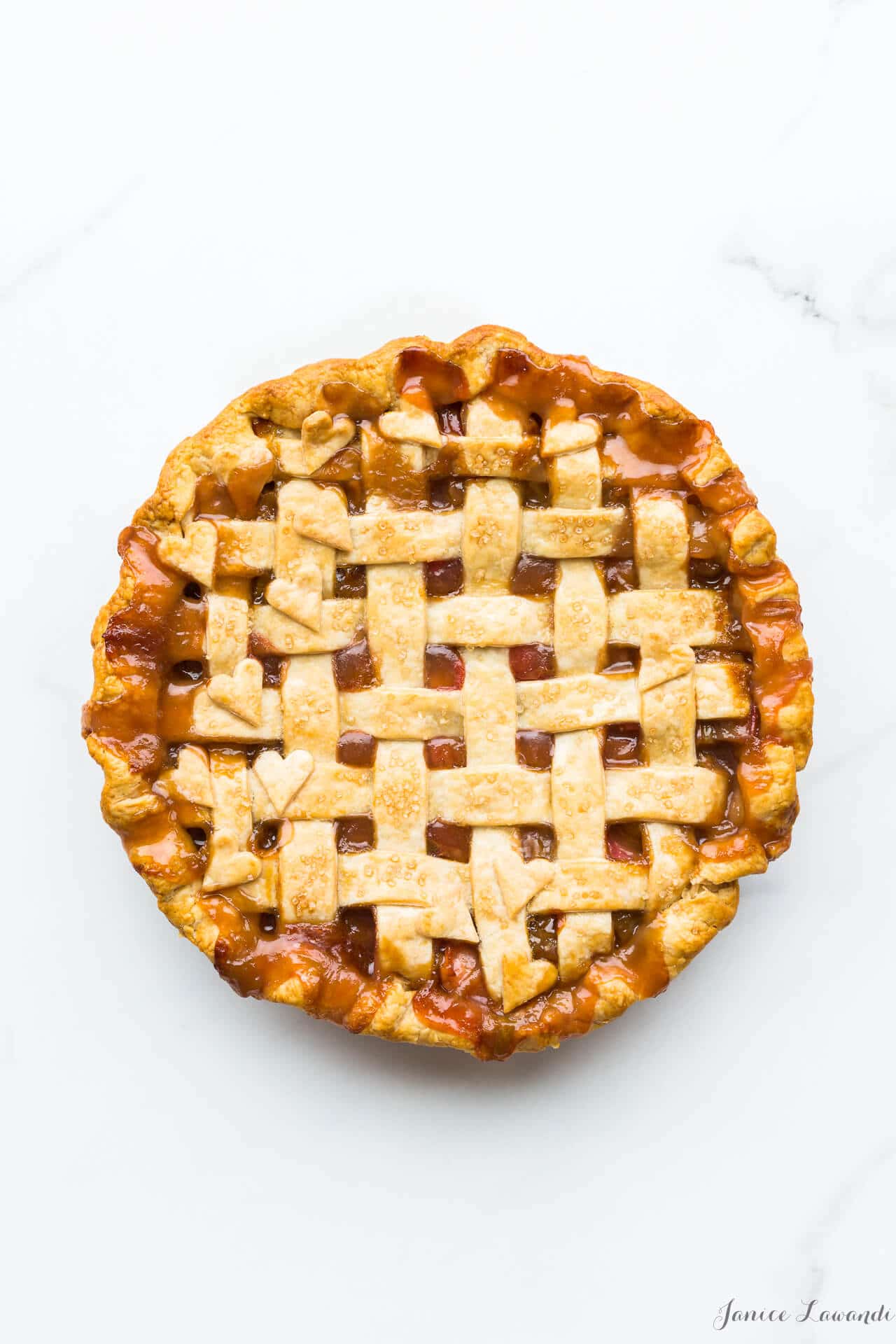 Homemade rhubarb pie with a lattice pie crust and heart cutouts