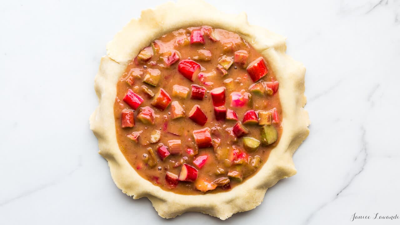 Pink rhubarb pie filling before baking the pie