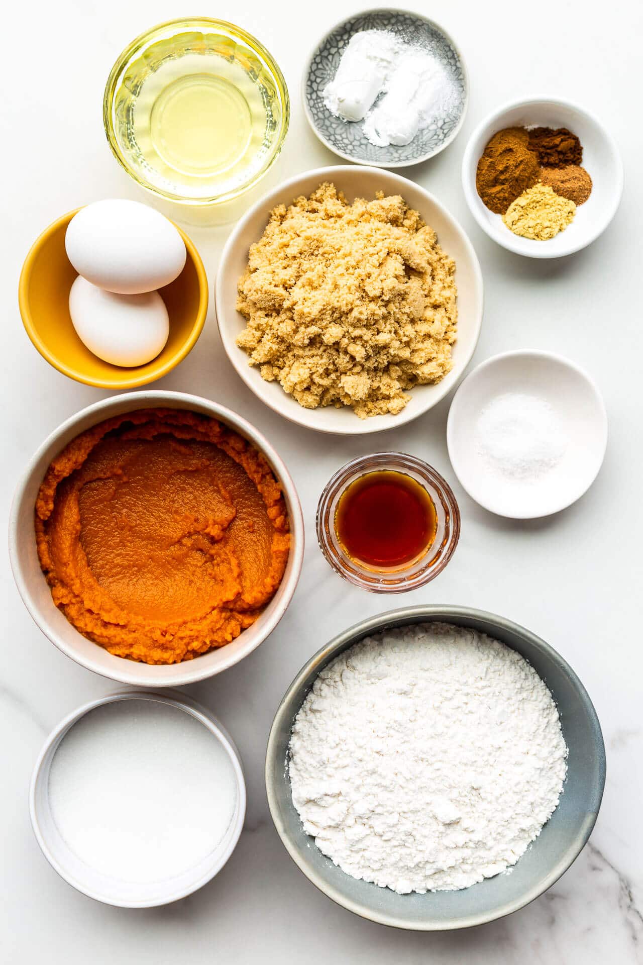 Ingredients to make a pumpkin loaf cake in a bread pan.