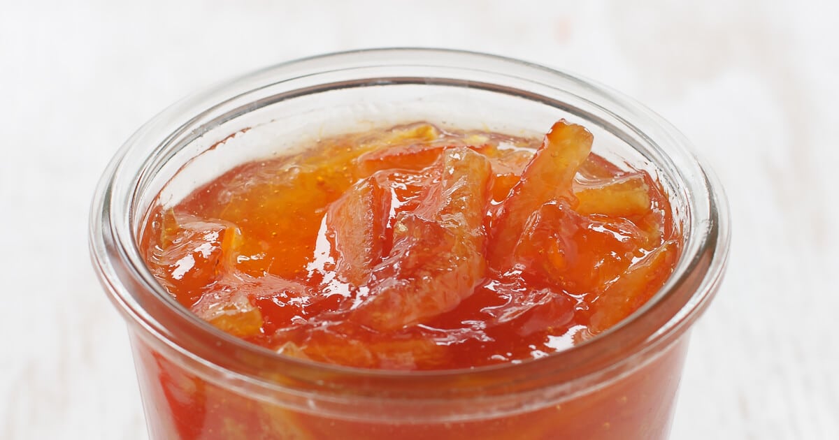An open jar of homemade thick-cut orange marmalade