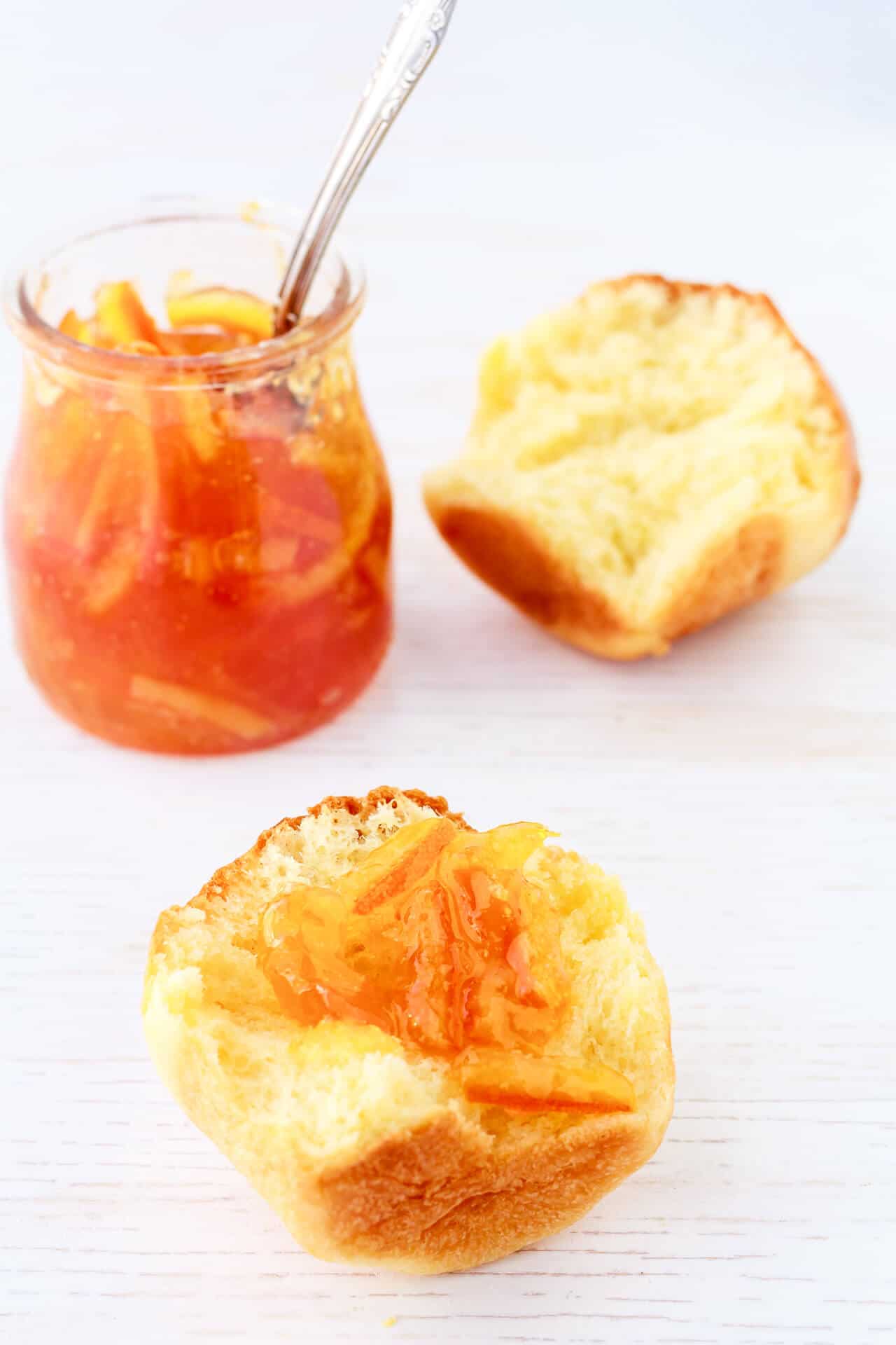 A jar of marmalade served with a brioche bun