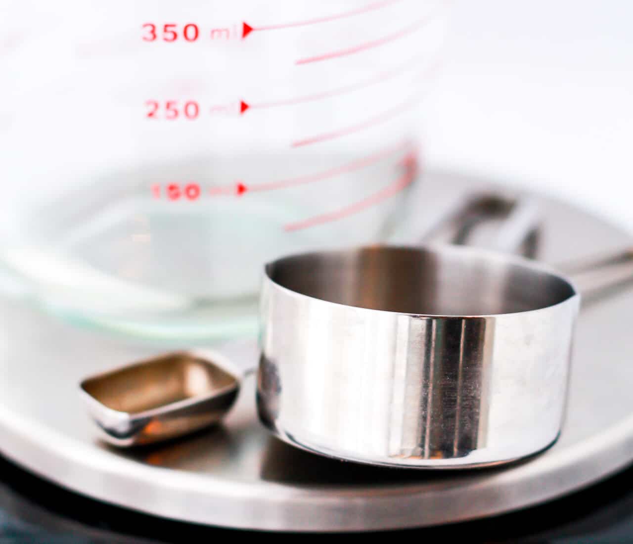 a liquid measuring cup, a tablespoon, and a 1 cup dry measuring cup