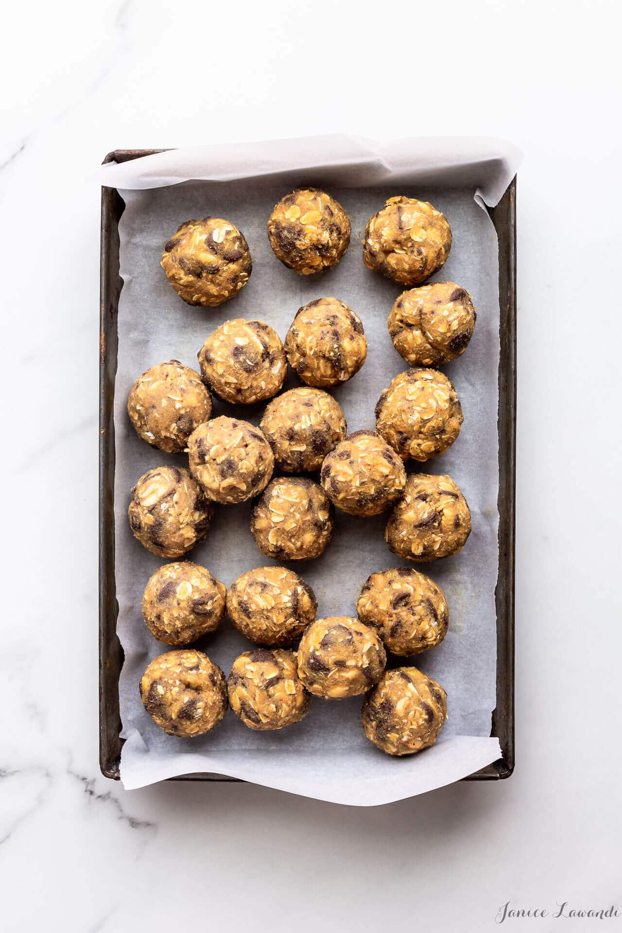 Oatmeal chocolate chunk cookie dough made with rolled oats, chunks of milk chocolate, and salted peanuts