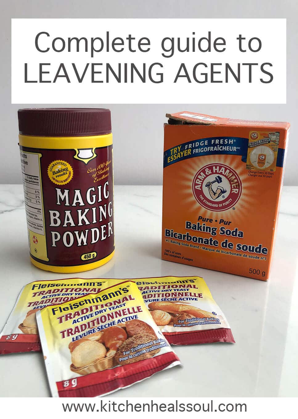 Burgundy and yellow container of Magic baking powder, an orange box of Arm & Hammer baking soda, and packets of Fleischman's traditional yeast