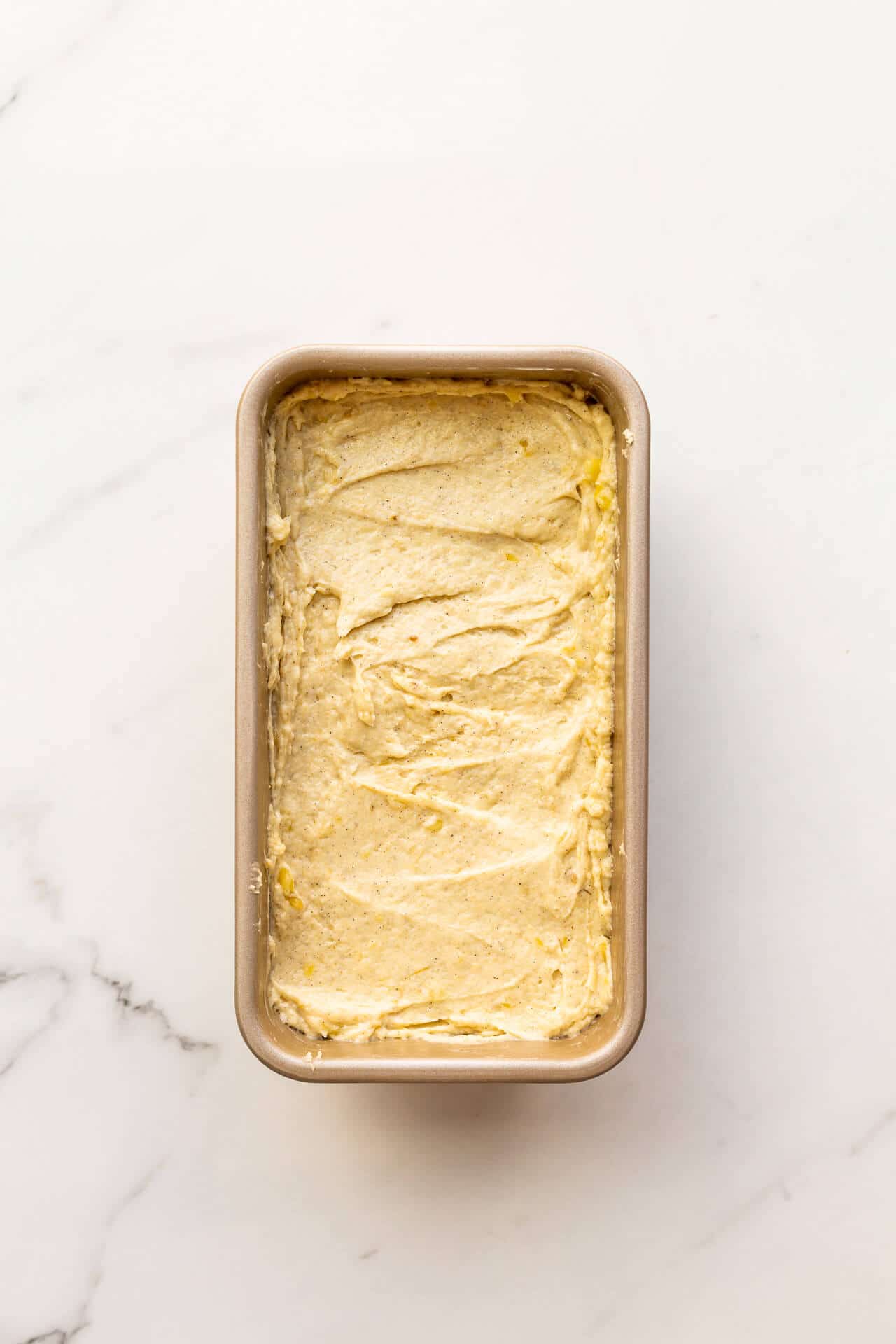 Banana bread cake batter in a loaf pan ready for the oven