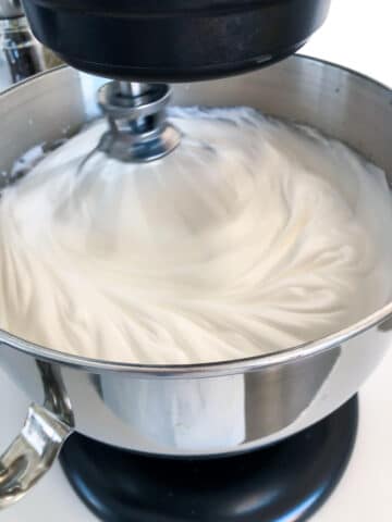 Whipping egg whites to stiff, glossy peaks like a pillowy meringue