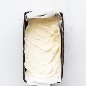 Freshly churned cardamom ice cream transfered to a big dark loaf pan to chill until frozen solid