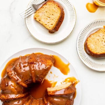 Serving slices of a big apple bundt cake on small dessert plates