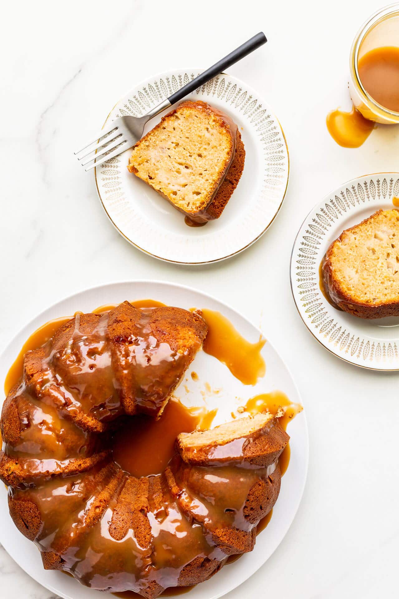 Serving slices of a big apple bundt cake on small dessert plates