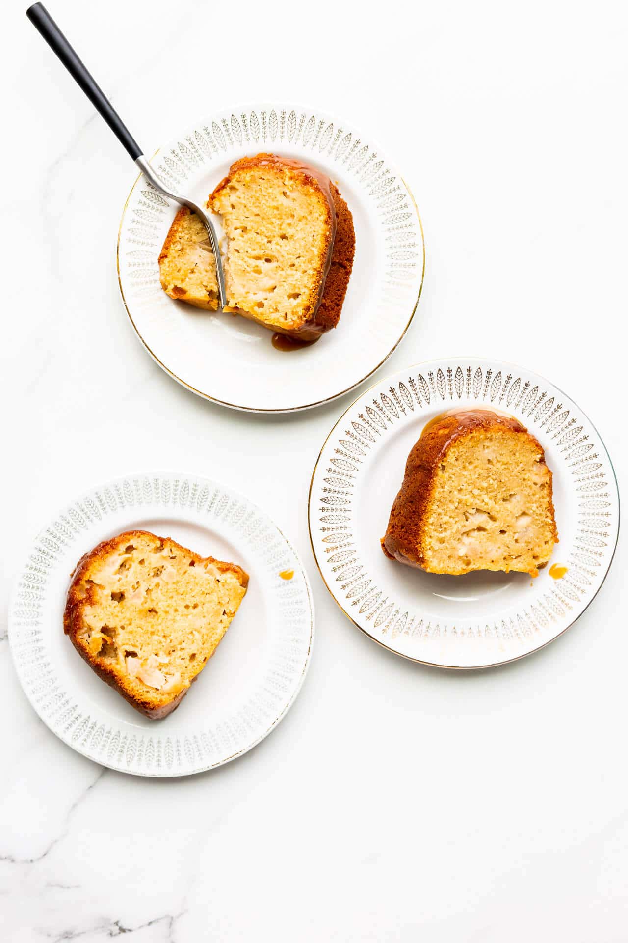 Slices of apple bundt cake served on small dessert plates