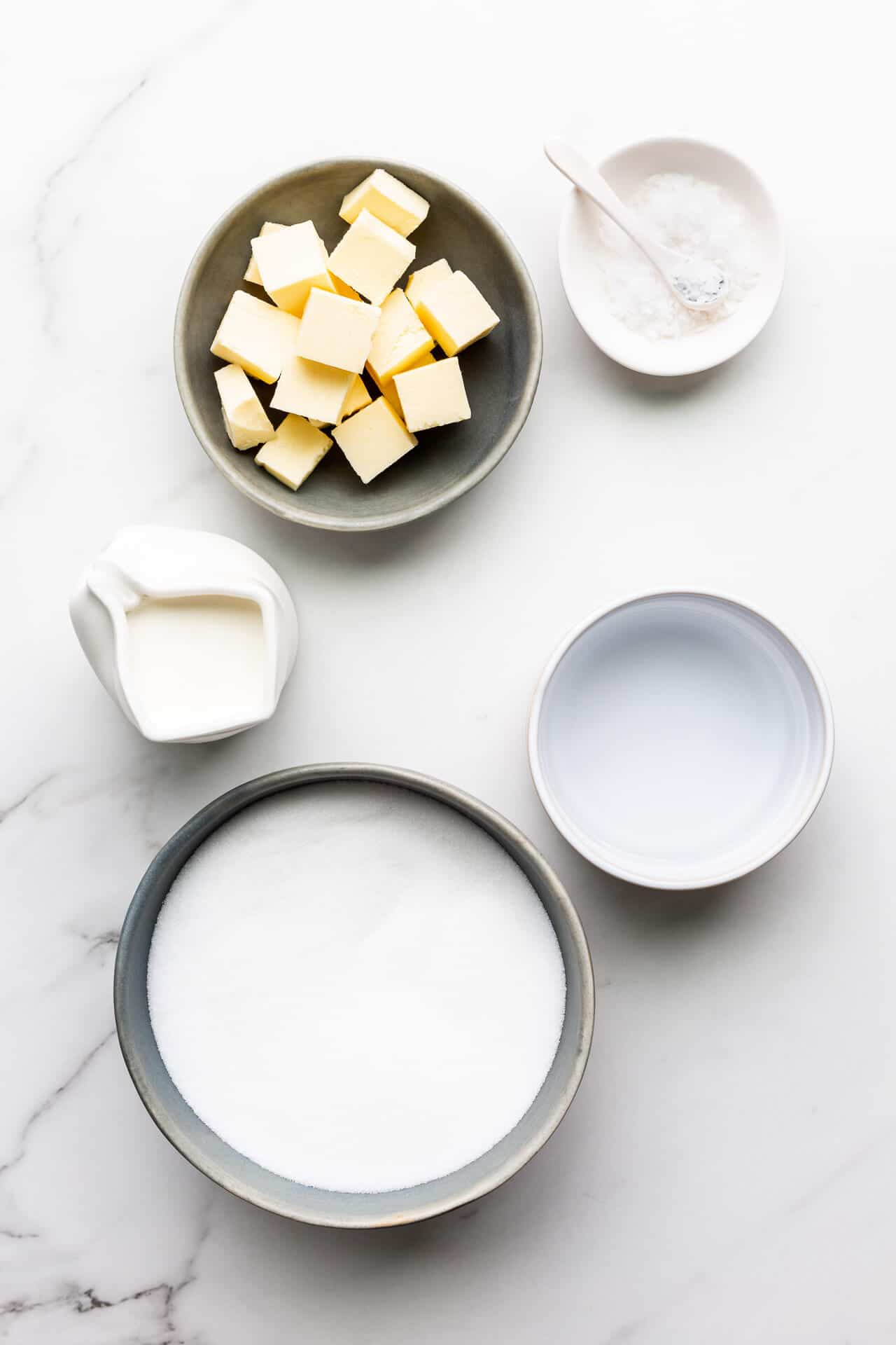 Ingredients for salted caramels include butter, salt, cream, sugar, and water