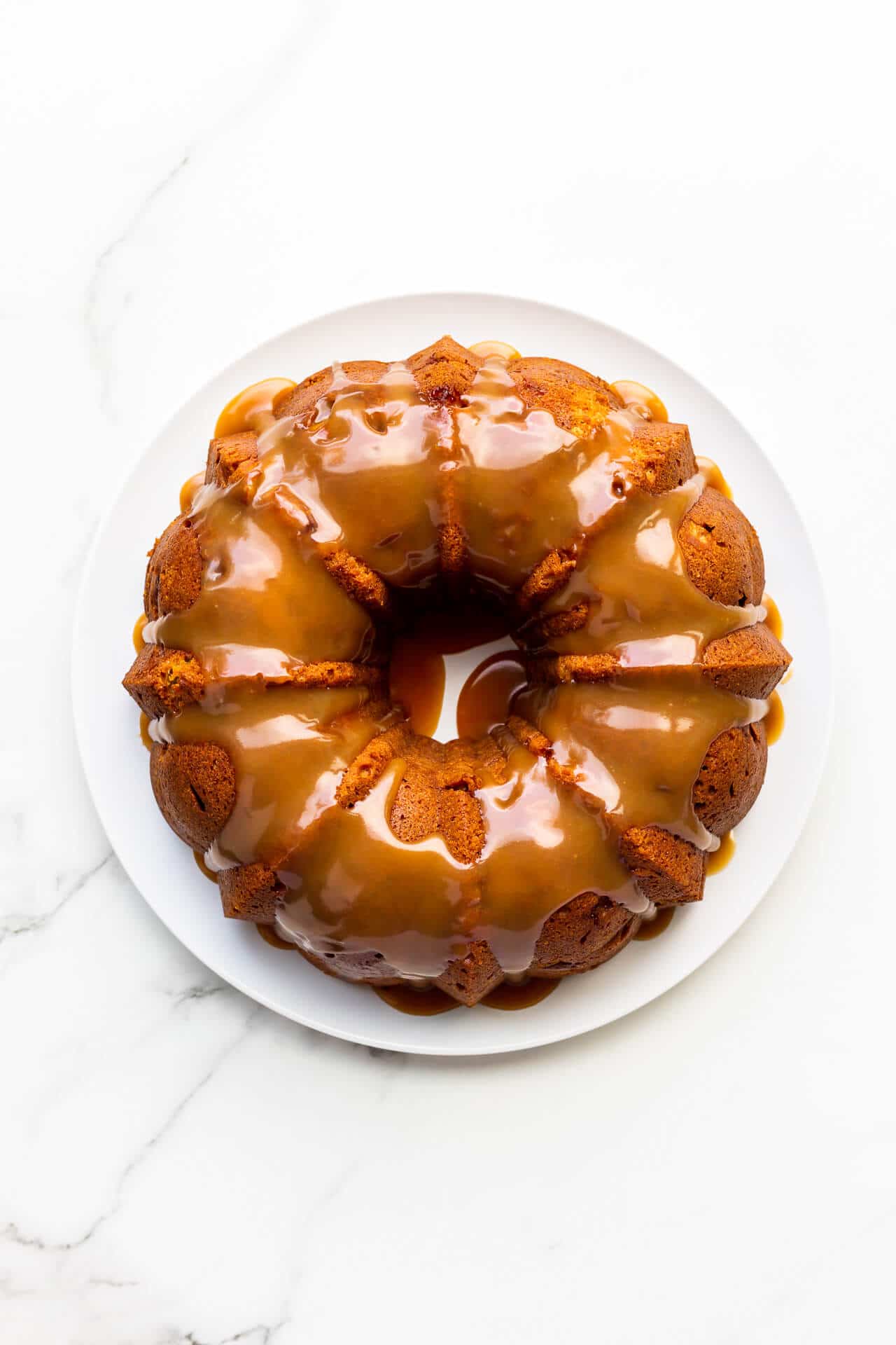 Bundt cake coated with shiny salted caramel sauce