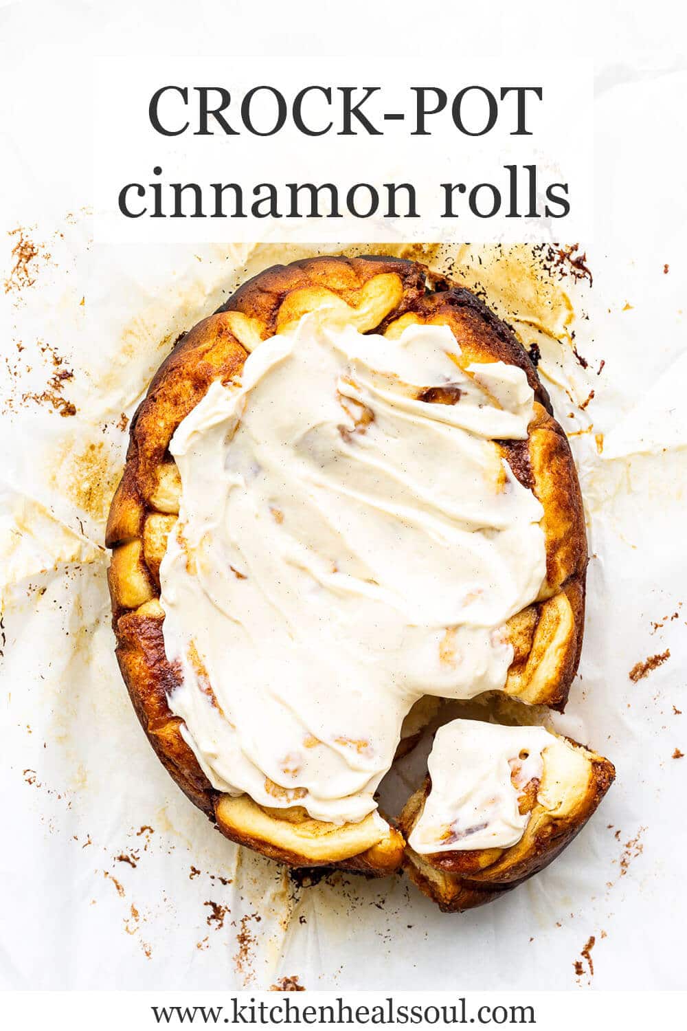 Crock-Pot cinnamon rolls iced with one pulled apart from the others