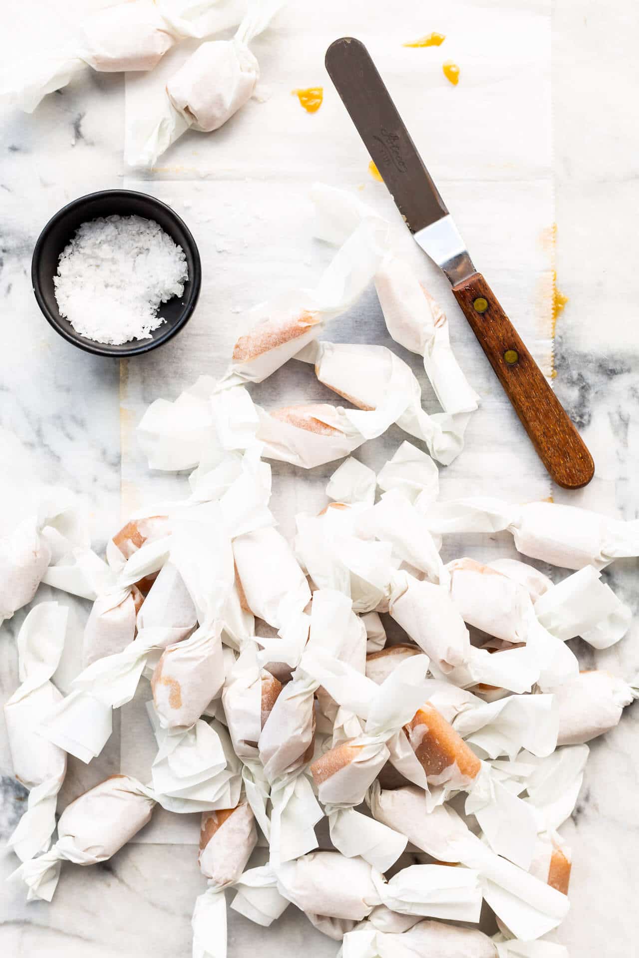 Homemade salted caramels all wrapped un in parchment paper