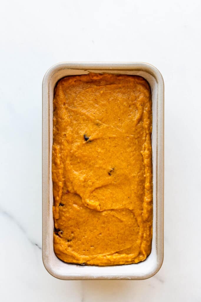 Pumpkin cranberry bread in a loaf pan before baking