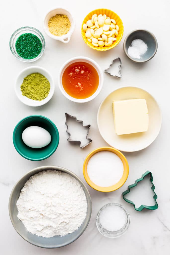 Ingredients and cookie cutters to make matcha cookies measured out and ready for baking.