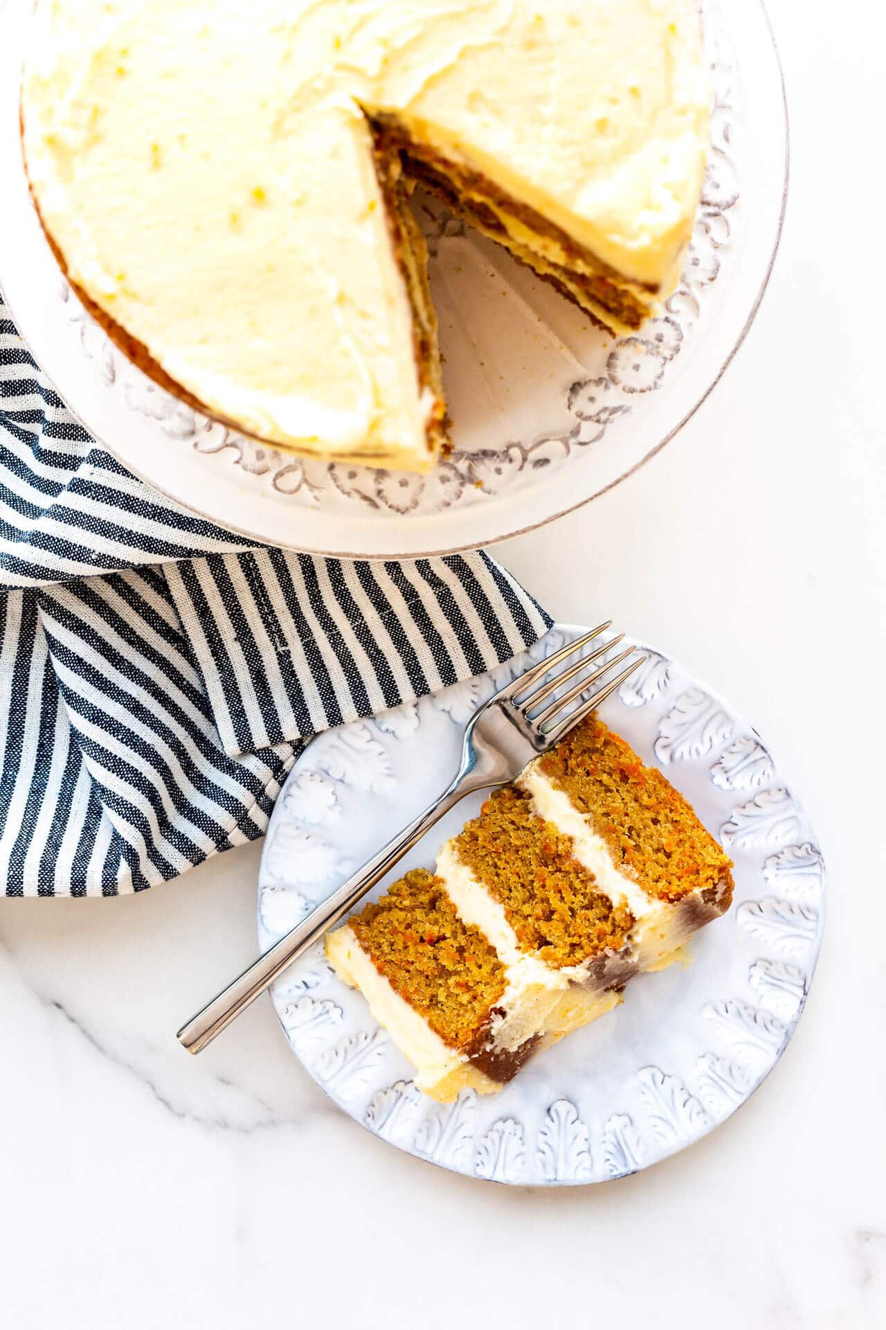 Carrot cake being served on plates.