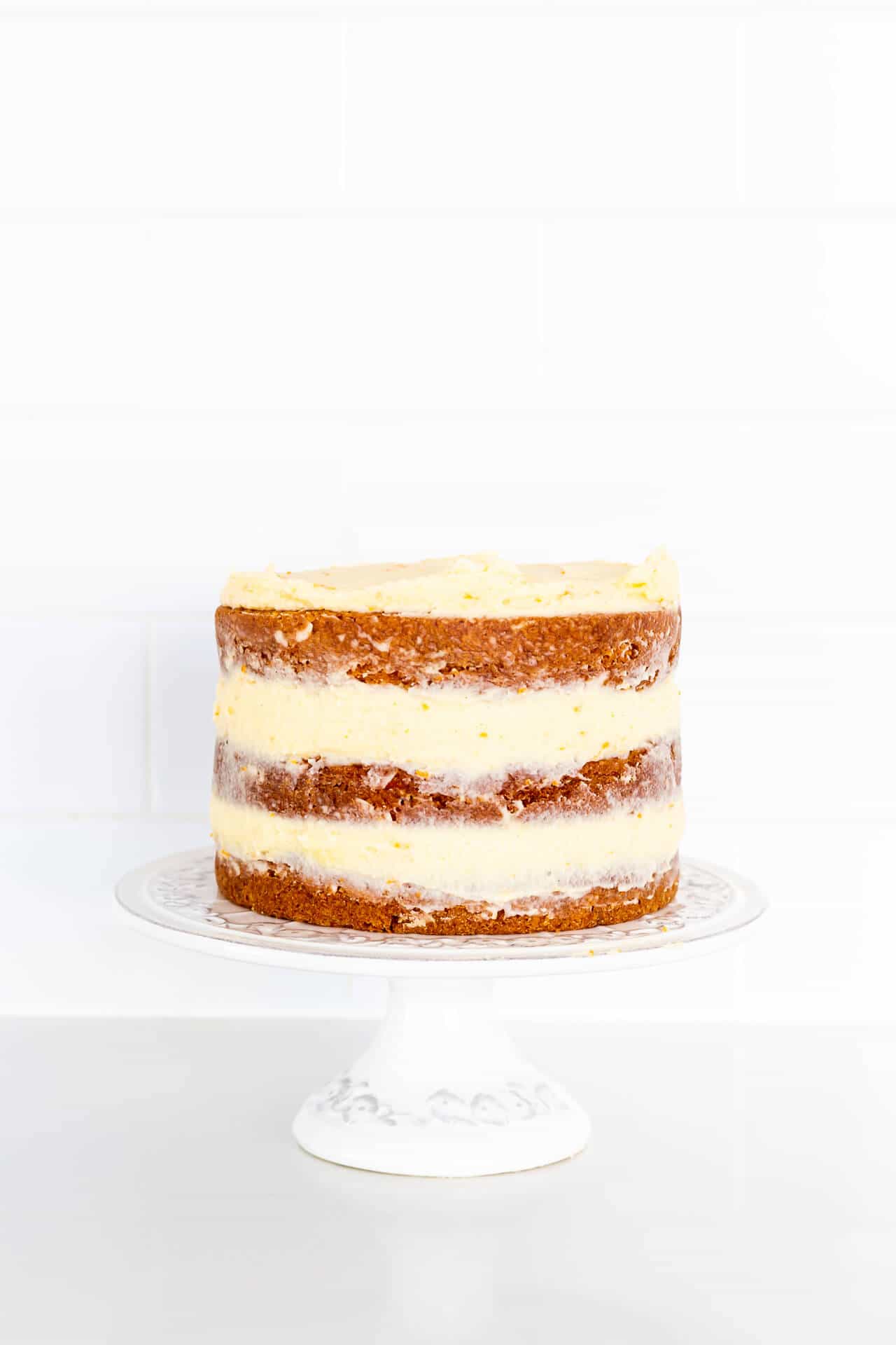 A cake stand with a carrot cake.