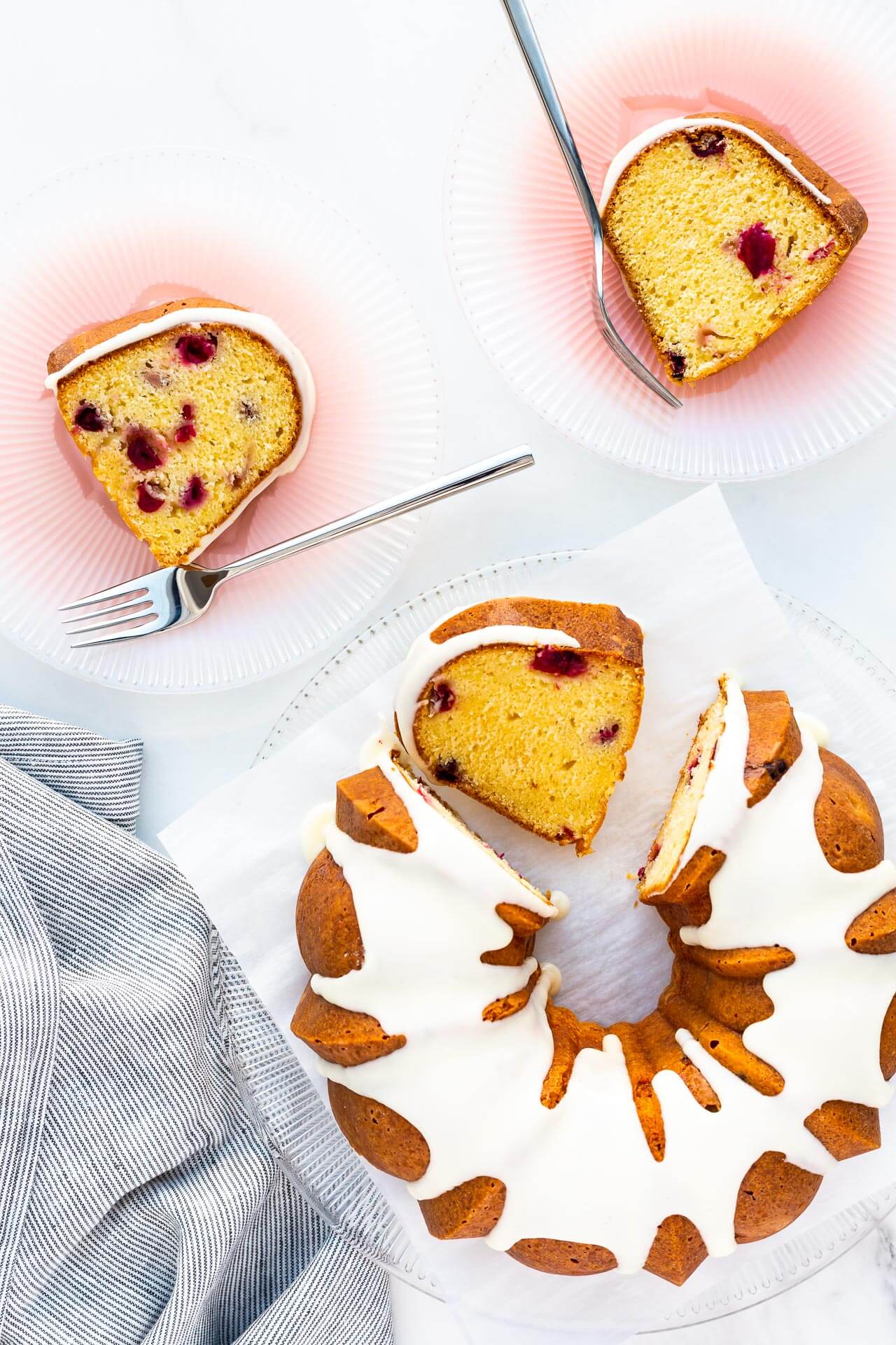 Slicing an orange cranberry bundt cake.