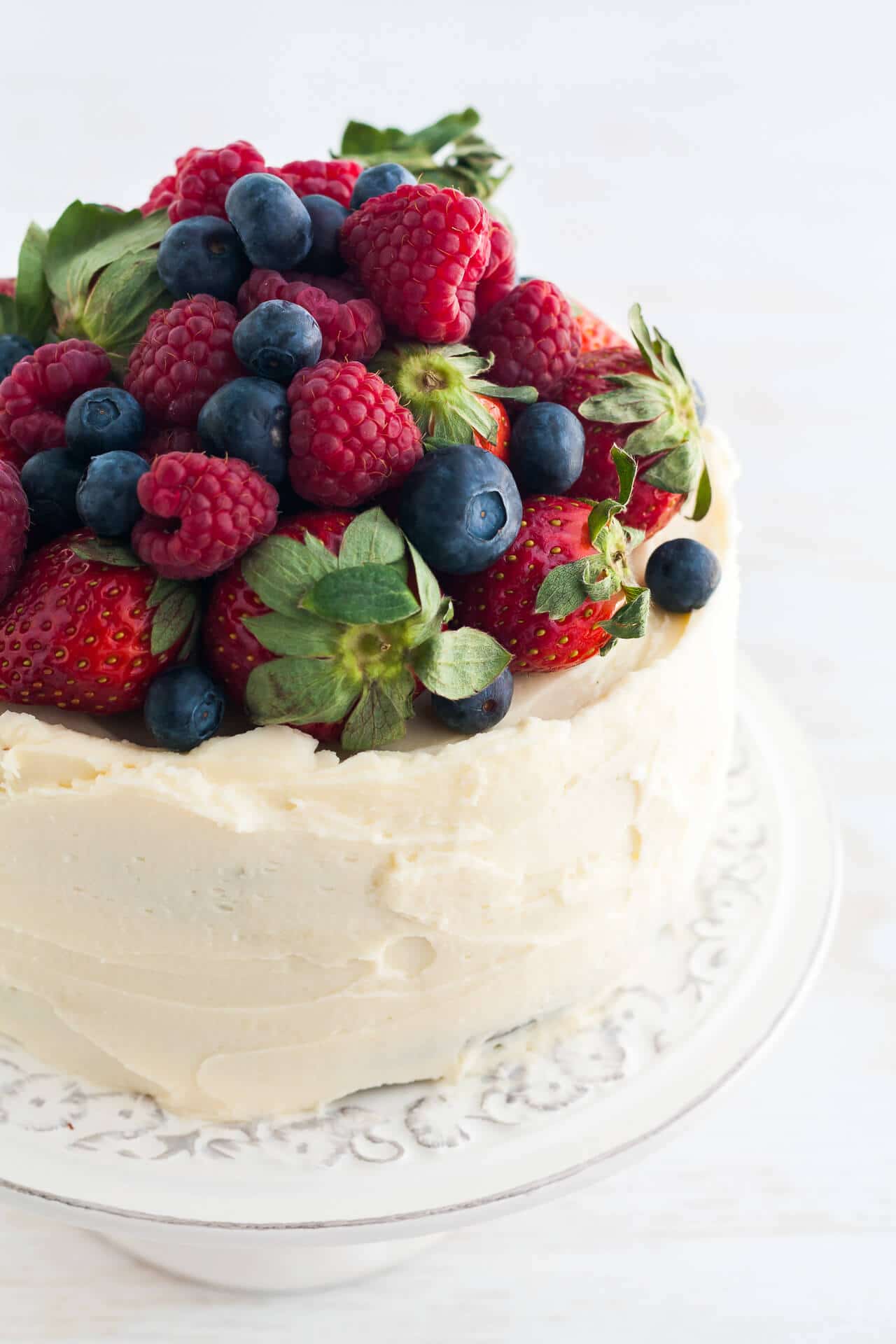 Chocolate layer cake with cream cheese frosting and berries.