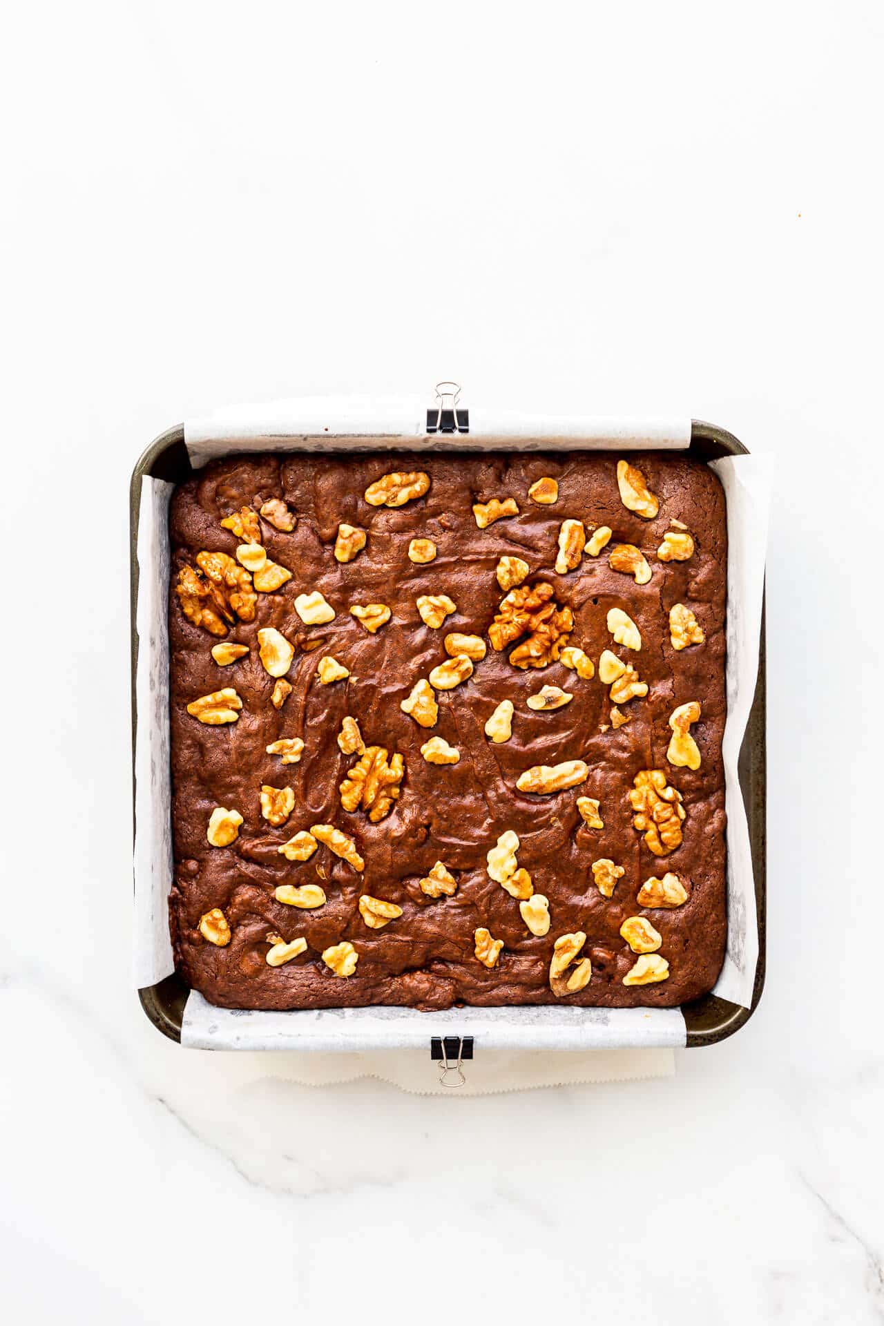 A pan of brownies with walnuts, freshly baked.
