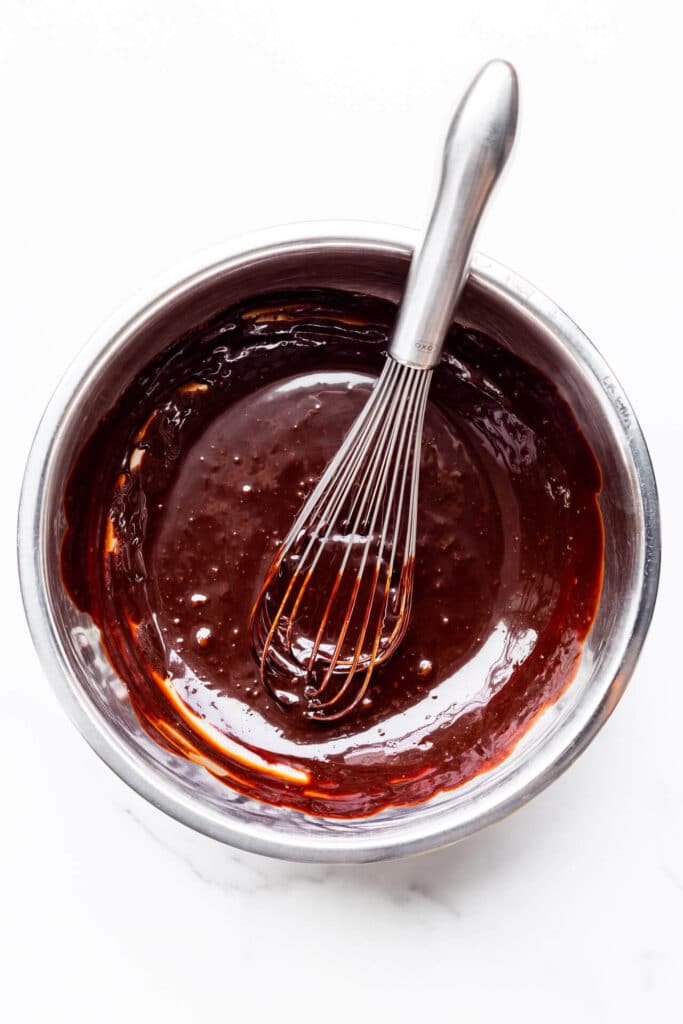 A bowl of homemade chocolate fudge sauce for sundaes and banana splits.