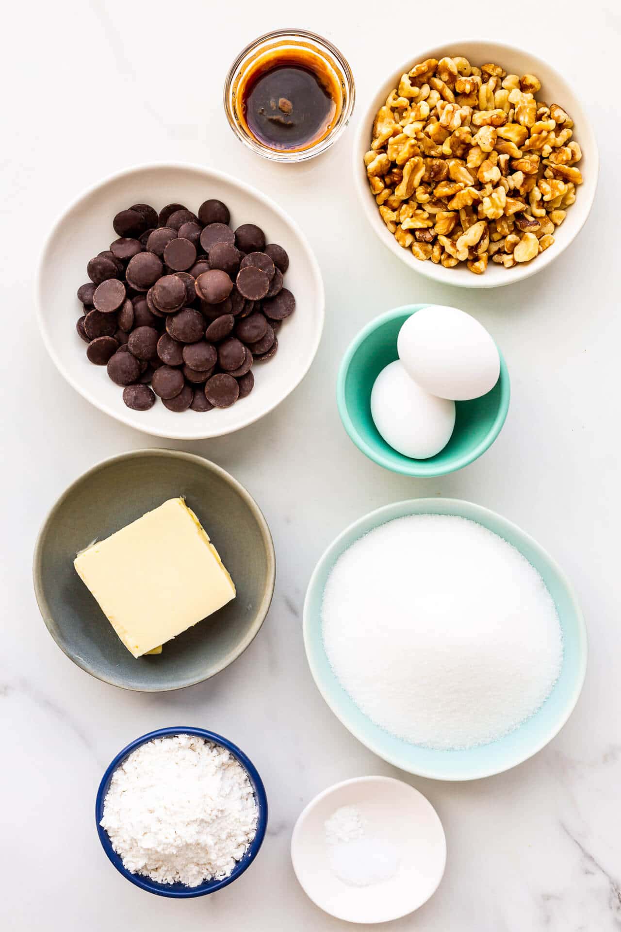 Ingredients needed to make brownies with walnuts, measured out and ready to be mixed.