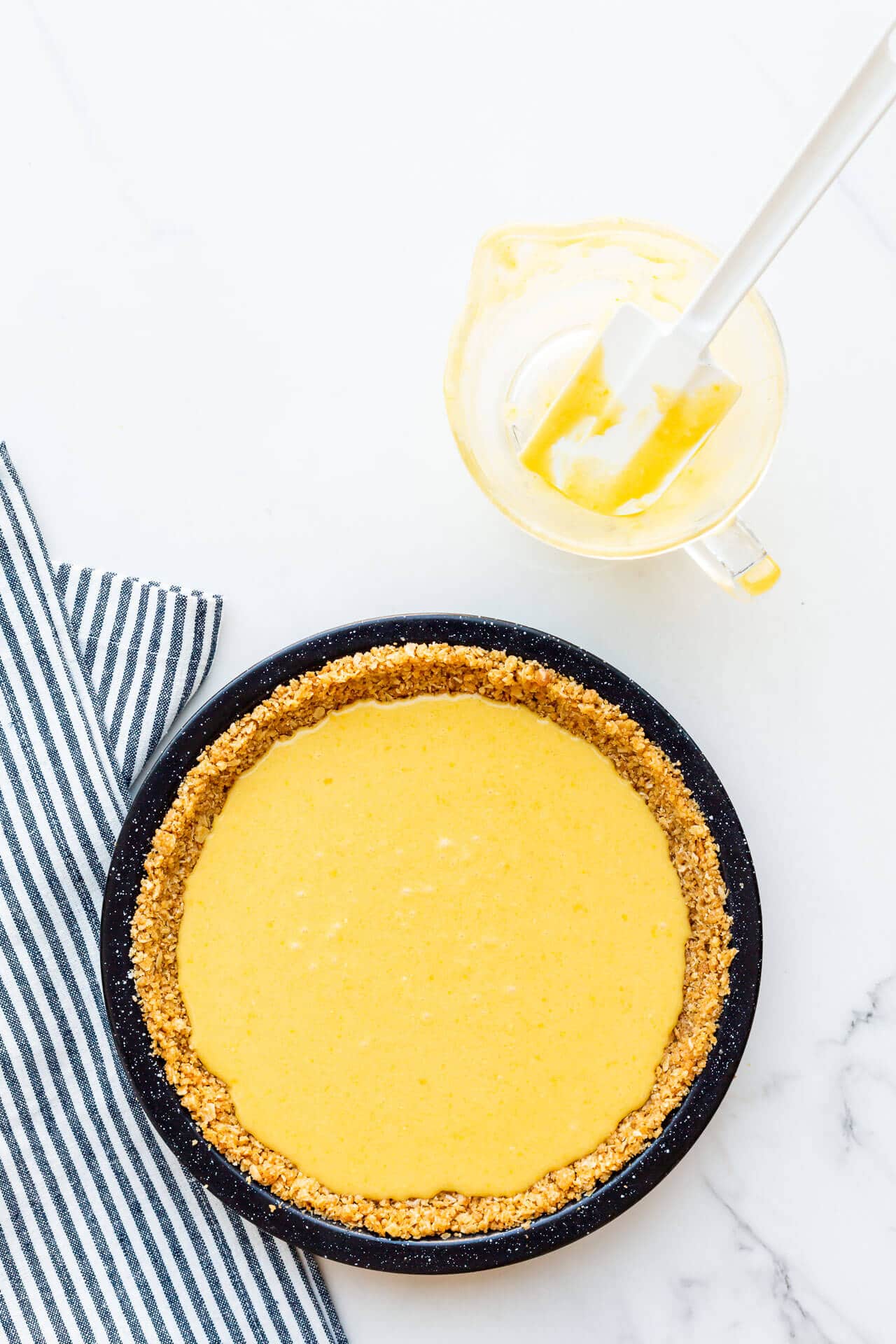 Filled Milk Bar pie with graham cracker crust before baking in oven to set.