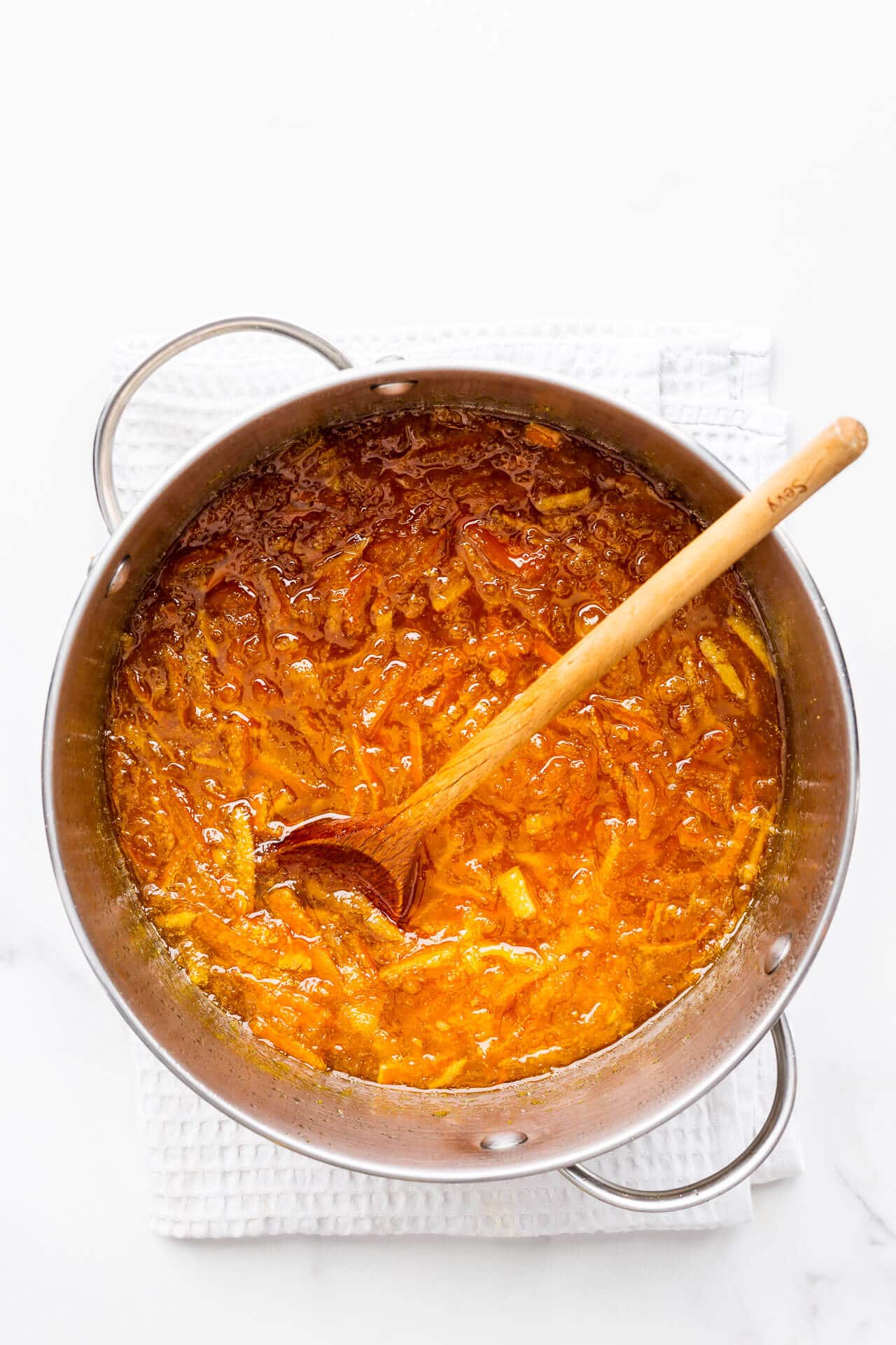 A pot of boiled homemade orange marmalade ready to be canned in jars.