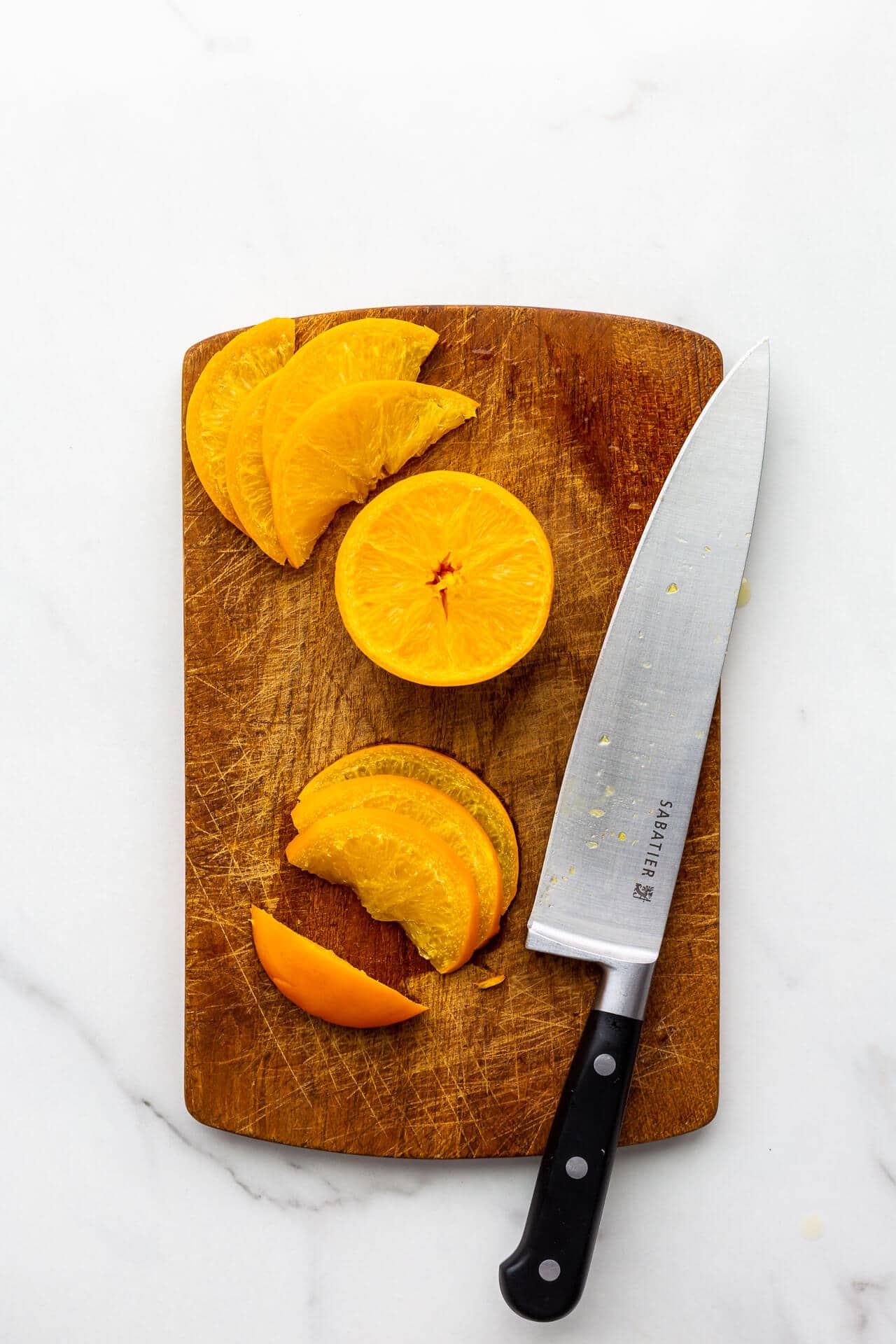 Slicing boiled oranges to make orange marmalade.