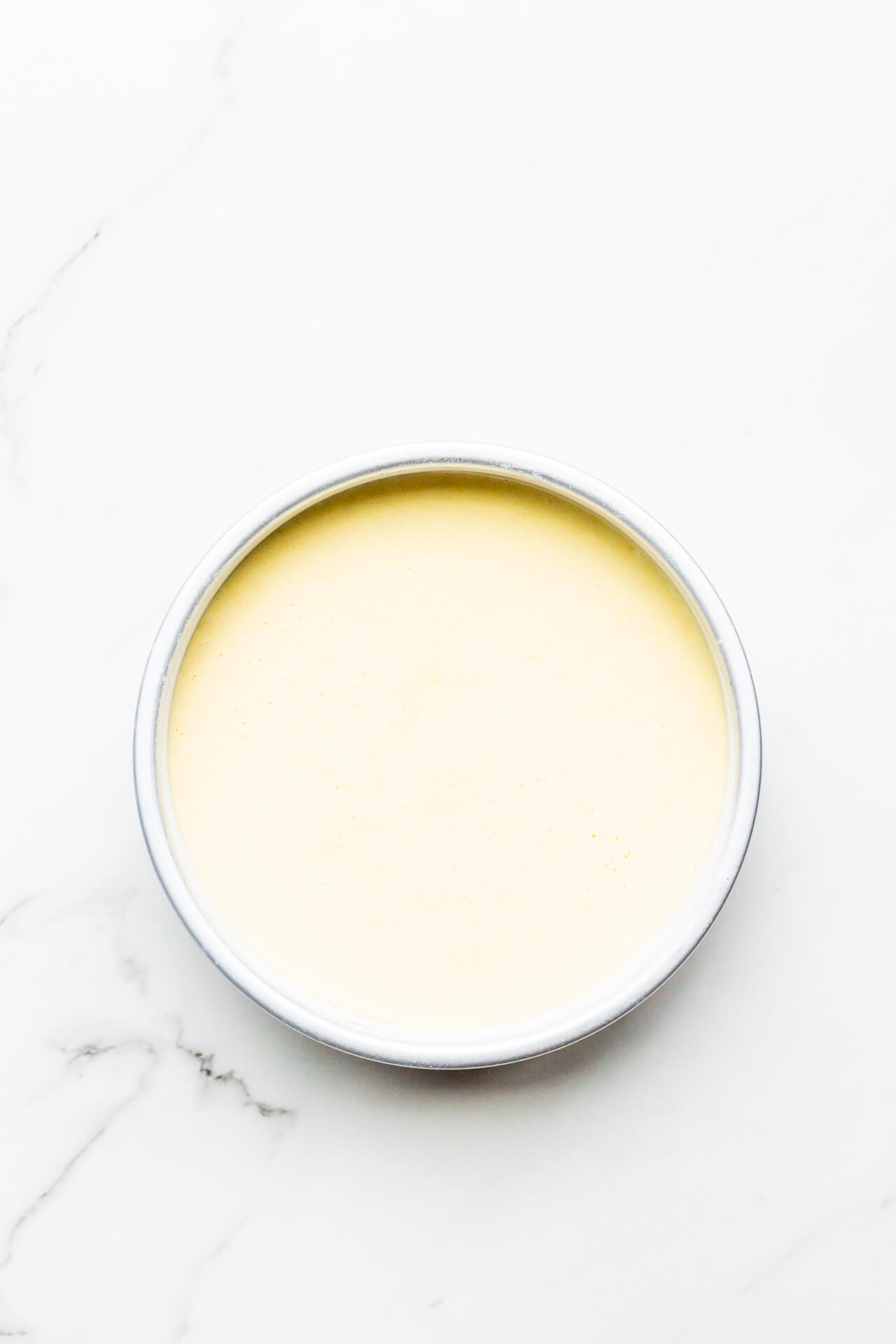 Sponge cake batter in cake pan ready to be baked.