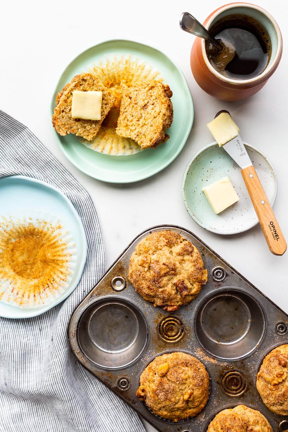 Freshly baked carrot muffins being served on plates.