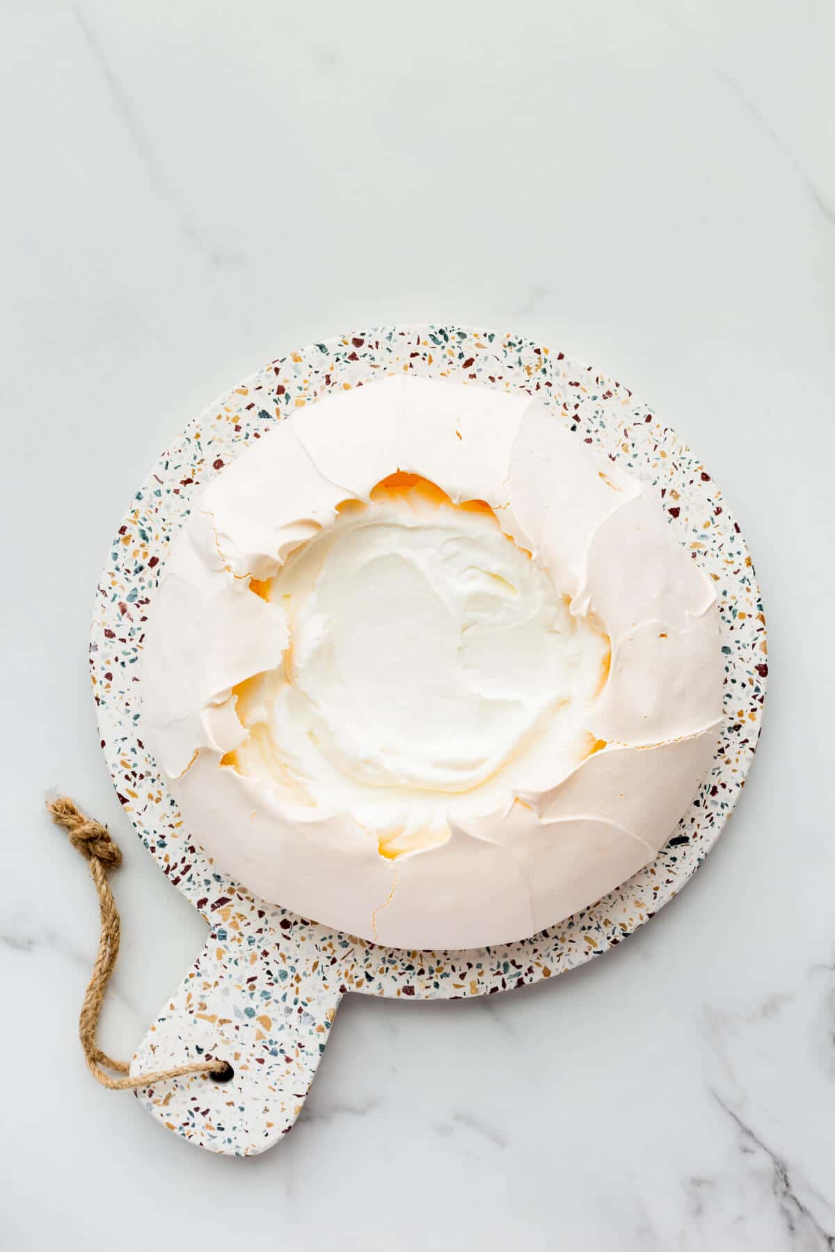 Pavlova cake filled with whipped cream.
