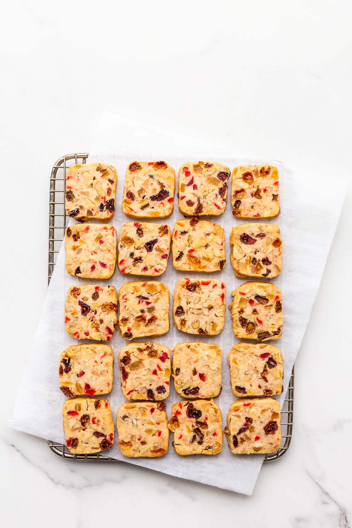 Fruitcake cookies cooling on a wire rack.