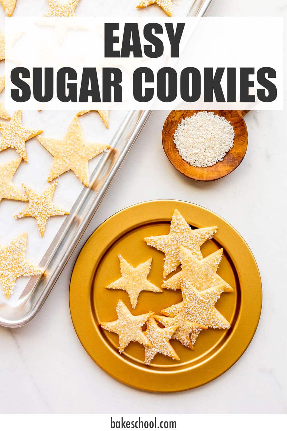 Cut-out sugar cookies shaped like stars and coated in sparkly sanding sugar served on a gold plate.