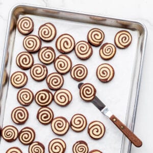 A sheet pan of freshly baked pinwheel cookies.