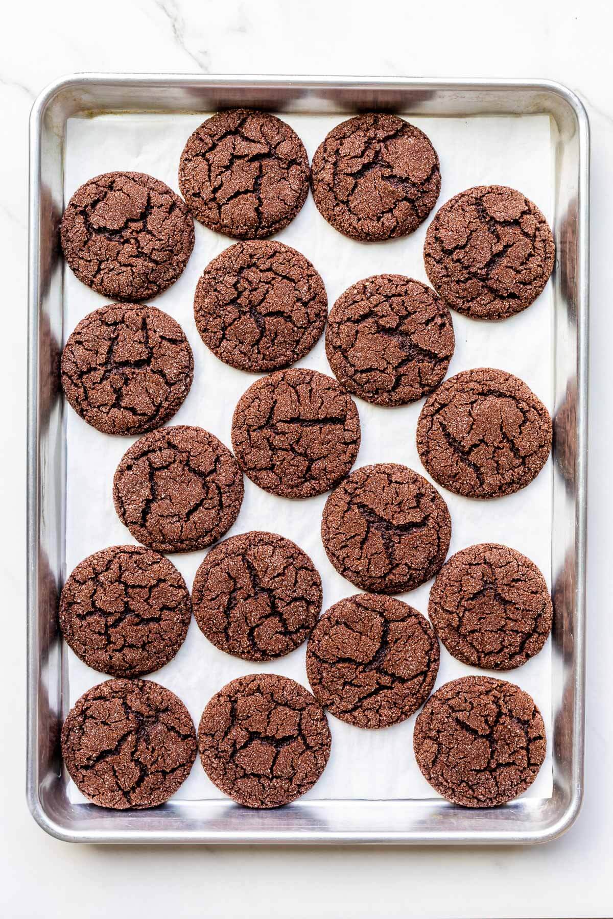 A sheet pan of freshly baked chocolate sugar cookies.