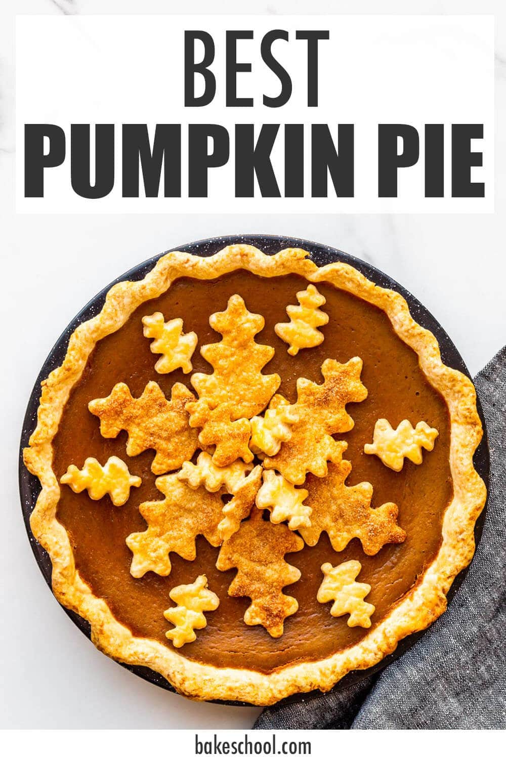 Pumpkin pie topped with leaf-shaped pie crust cookie cutouts to decorate it.