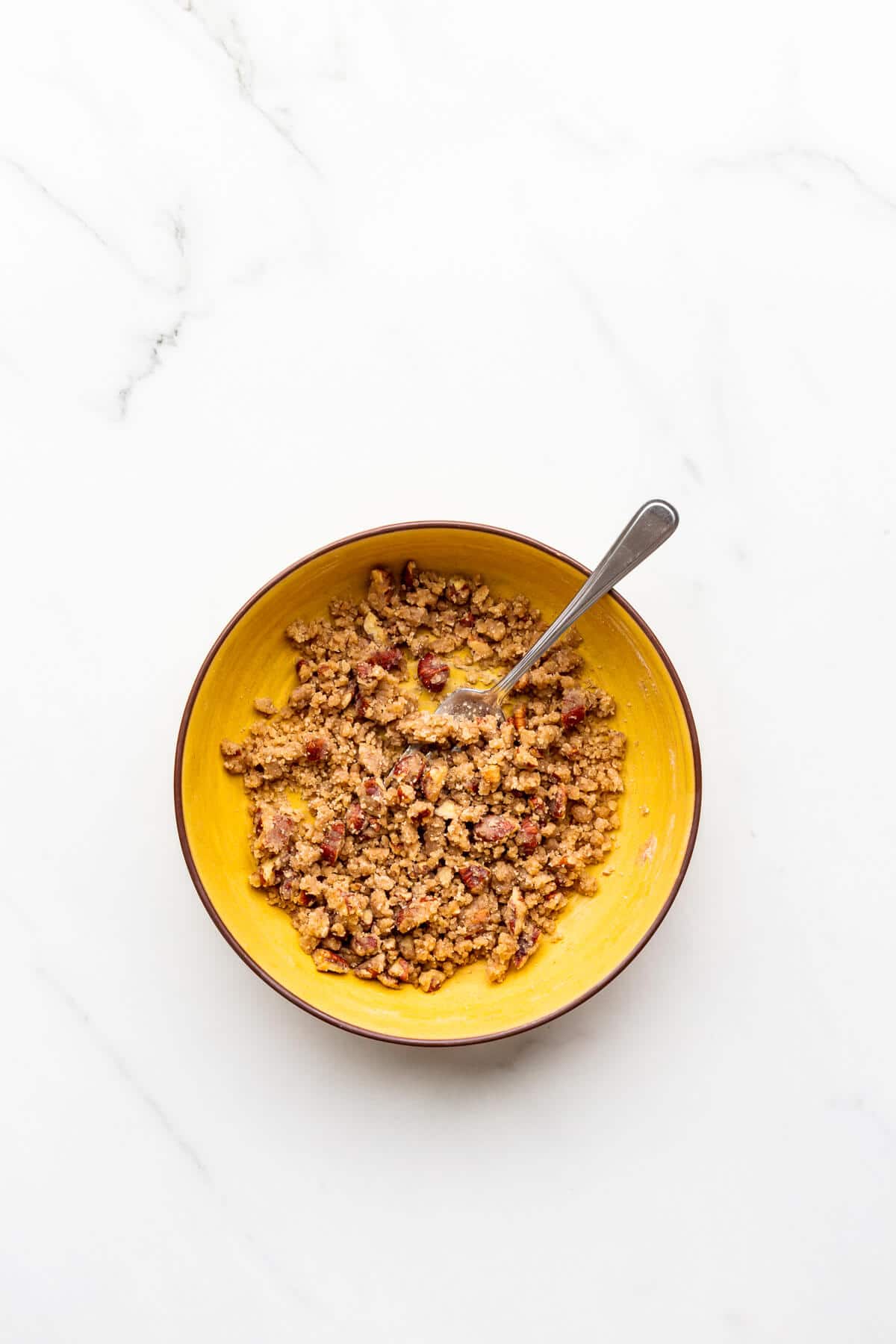 A bowl of cinnamon streusel topping for muffins.