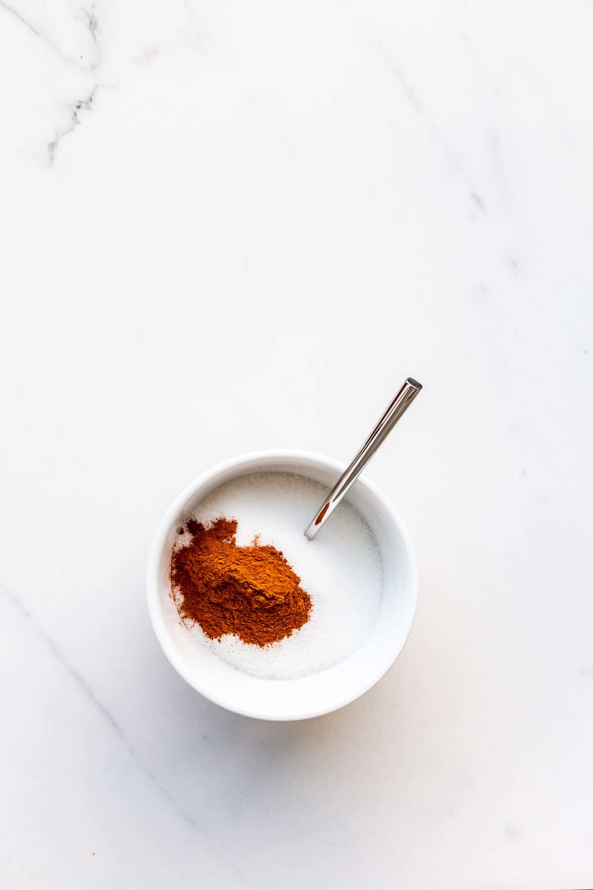 Mixing cinnamon with sugar to make cinnamon sugar.