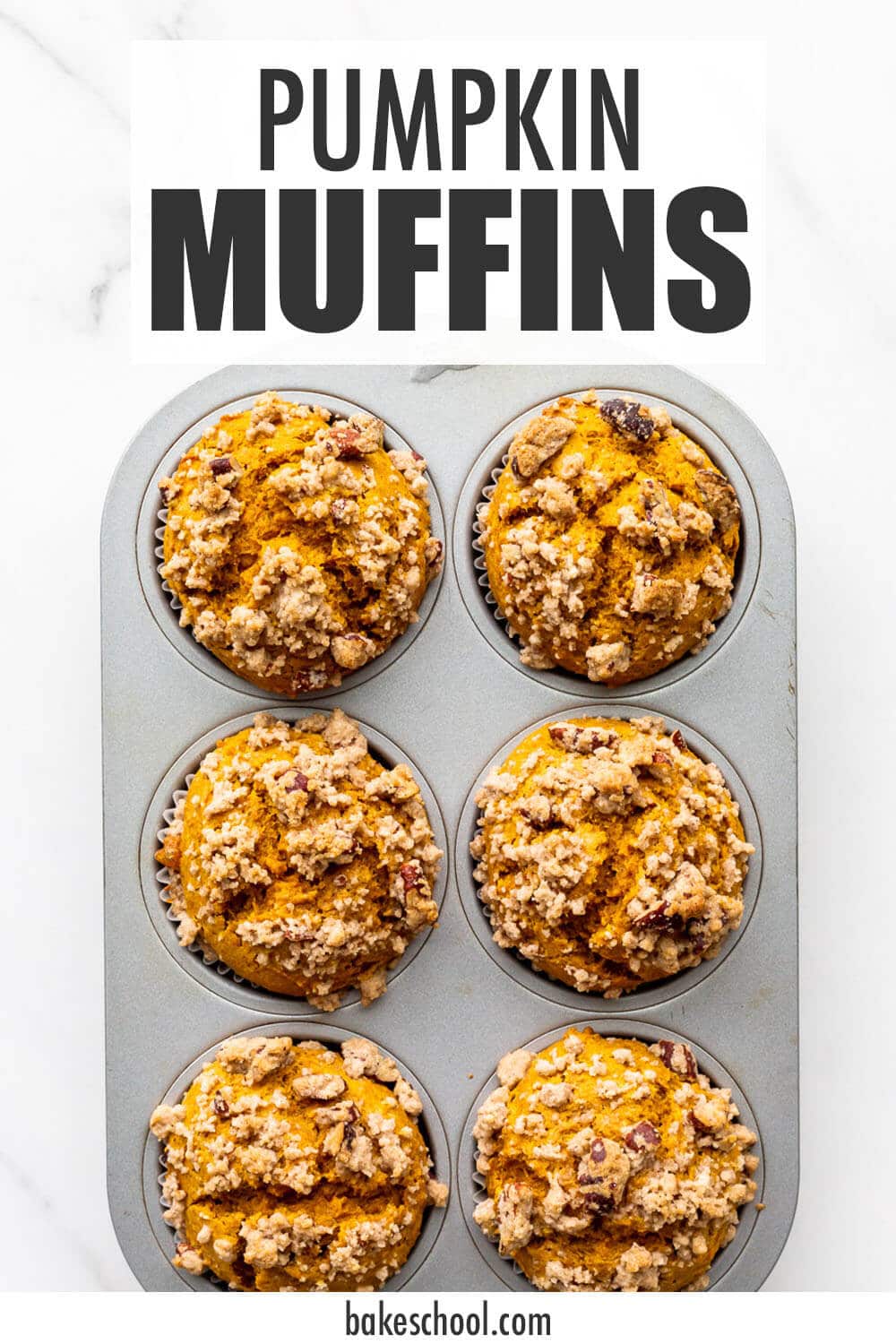 A muffin pan of pumpkin muffins, freshly baked.