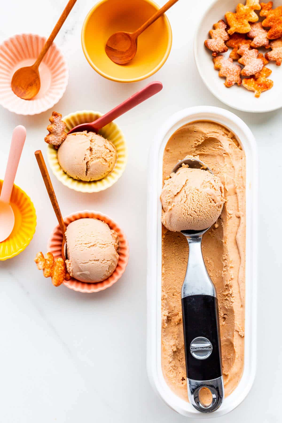 Scooping pumpkin pie ice cream into little bowls to serve.