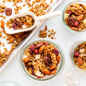 Transferring homemade gingerbread granola to jars to give out as gifts at Christmas time.