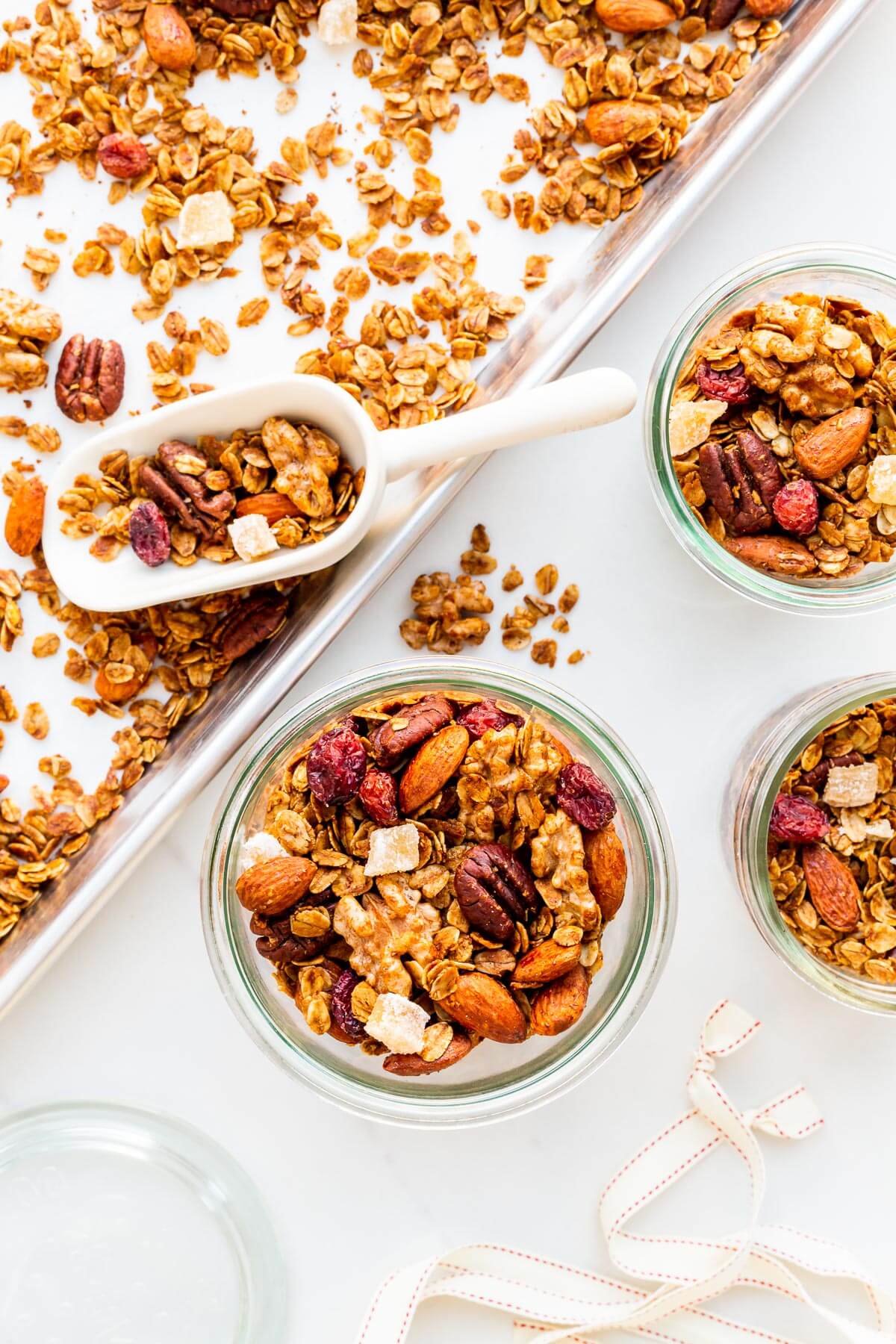 Transferring homemade granola to jars to give out as edible Christmas gifts.