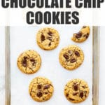 A sheet pan of freshly baked chocolate chip cookies made with chunks of chocolate.