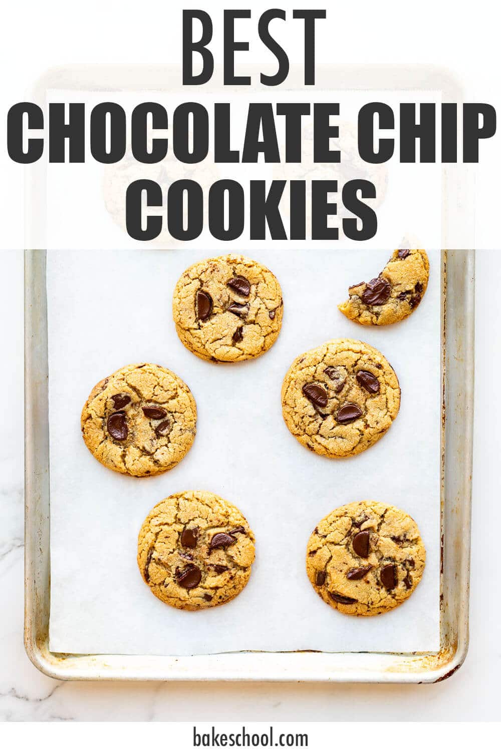 A sheet pan of freshly baked chocolate chip cookies made with chunks of chocolate.